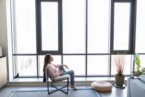 young-woman-relaxing-modern-chair-home
